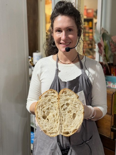 Holding a cut sourdough loaf at a workshop