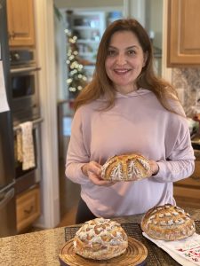 sourdough student hold her bread